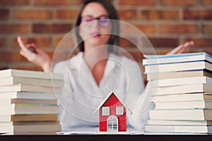 Realtor with books and house photo