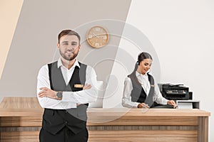 Young receptionists in professional uniform