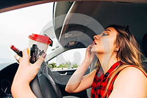 Young reckless girl in car doing make up photo