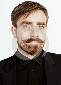 Young red hair man with beard and mustache in black suit on white background