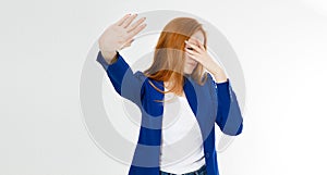 Young red hair woman making a rejection pose and facepalm on a white background. Negative human emotion face expression feeling photo