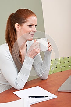 Young red hair woman at office with coffee