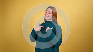 Young red hair woman posing isolated on yellow color background studio.