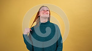 Young red hair woman posing isolated on yellow color background studio.