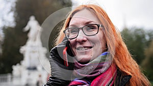 Young red hair woman using cell phone in Vienna, close up