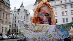 Young red hair woman using city map on square in Vienna, wide angle, close up