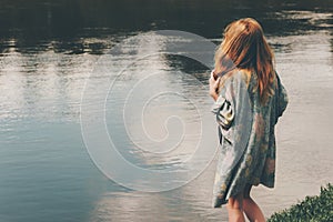 Young red hair woman walking at river alone