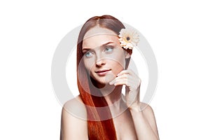 Young red-haired female with flower in hair