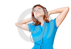 Young red-haired girl listen to music and dance