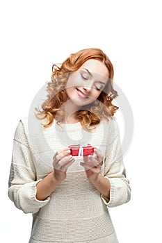 Young red-haired happy smiling girl holding gift