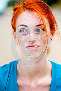 Young redhead beautiful freckled woman thinking photo
