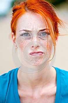 Young redhead beautiful freckled woman troubled