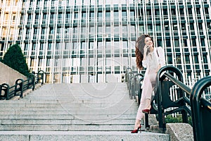 Young redhead business woman walking on the stairs