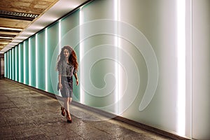 Young redhead business woman walking to work