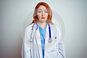 Young redhead doctor woman using stethoscope over white isolated background looking sleepy and tired, exhausted for fatigue and