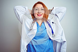 Young redhead doctor woman using stethoscope over white isolated background relaxing and stretching, arms and hands behind head