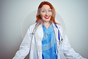 Young redhead doctor woman using stethoscope over white isolated background smiling cheerful with open arms as friendly welcome,