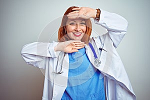 Young redhead doctor woman using stethoscope over white isolated background Smiling cheerful playing peek a boo with hands showing