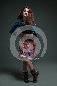 Young redhead female model on plain background with copyspace