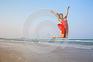 Young redhead girl jumping