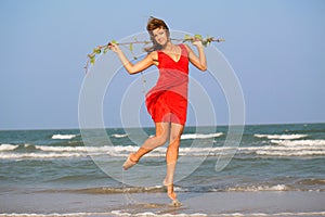 Young redhead girl in red dress