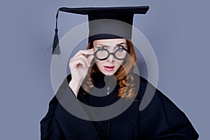 Graduate girl in square academic cap and mantle