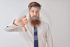 Young redhead irish businessman standing over isolated white background looking unhappy and angry showing rejection and negative