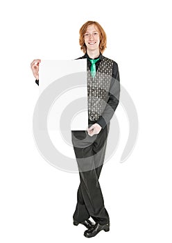 Young redhead man in costume for irish dance with empty banner