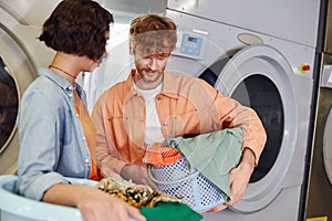 young redhead man holding basin with