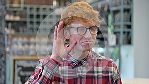 Young Redhead Man Listening Carefully