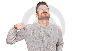 Young redhead man wearing casual winter sweater stretching back, tired and relaxed, sleepy and yawning for early morning