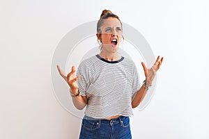 Young redhead modern woman wearing a bun over isolated background crazy and mad shouting and yelling with aggressive expression