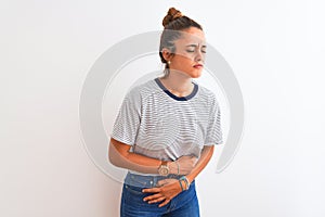 Young redhead modern woman wearing a bun over isolated background with hand on stomach because nausea, painful disease feeling