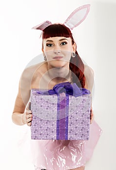 young redhead woman in a bunny suit with gifts