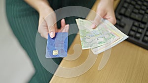 Young redhead woman business worker holding romanian leu banknotes and credit card at office