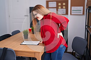 Young redhead woman business worker suffering for backache at office