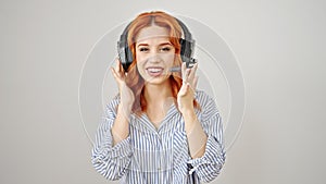 Young redhead woman call center agent speaking over isolated white background