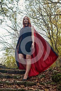 Young redhead woman in a forest