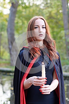 Young redhead woman in a forest