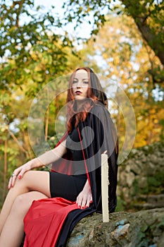 Young redhead woman in a forest