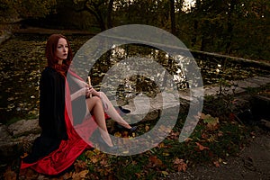 Young redhead woman in a forest