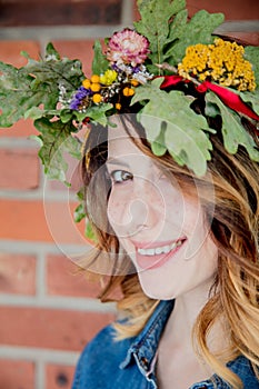 Young redhead woman with oak leaves wreath