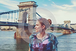 Young redhead woman posing at Chain Bridge, Budapest, Hungary