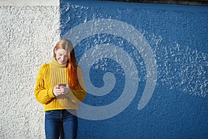 Young Redhead Woman Sending Text Message With Phone Outdoor