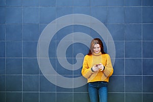 Young Redhead Woman Sending Text Message With Phone Outdoor