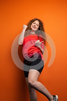 The young redhead woman in soccer football uniform having victiry mood as her team became winner, fan support concept.