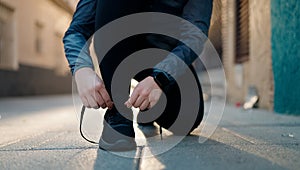 Young redhead woman wearing sportswear tying shoes at street