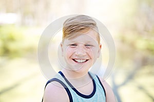 Young redheaded boy playing outside