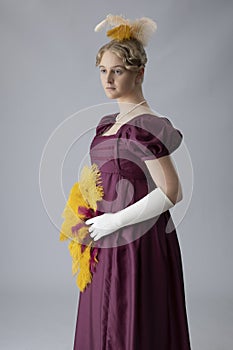 A young Regency woman in a an evening dress