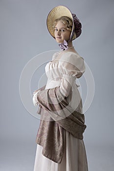 A young Regency woman in a pink dress